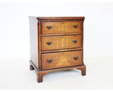 An 18th century style burr walnut chest of drawers, the quarter veneered and cross banded top above three graduated drawers, 