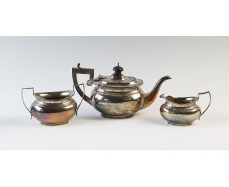 A George V silver bachelors three piece tea service, Charles S Green &amp; Co Ltd, Birmingham 1919, of typical compressed ova