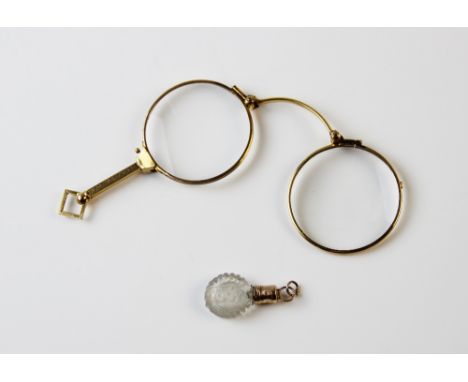 A gilt metal lorgnette engraved 'EAC - MMR 1873-1923' 8.5cm long and a gold mounted miniature glass scent bottle, 3.4cm long 