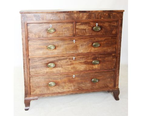 A George IV mahogany chest of drawers, the rectangular top above a frieze inlaid with parquetry banding, over two short and t
