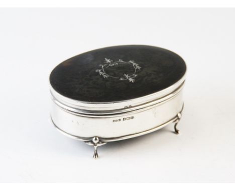 A silver inlaid tortoiseshell dressing table casket, Daniel Manufacturing Company Birmingham 1928, the oval casket inset with