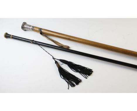A late 19th century malacca cane with silver mount and brass tip, 97cm long, along with an ebonised cane with button terminal