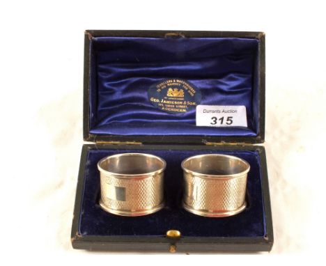A cased pair of engine turned Silver serviette rings, Birmingham 1978