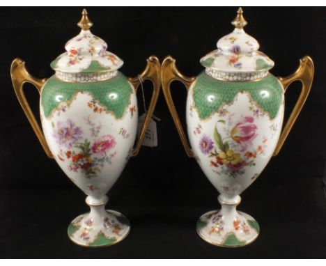 A pair of late 19th Century Porcelain twin handled vases and covers with green scale and floral decoration