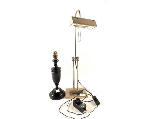 An adjustable desk lamp, wooden lamp base and a rectangular mirror