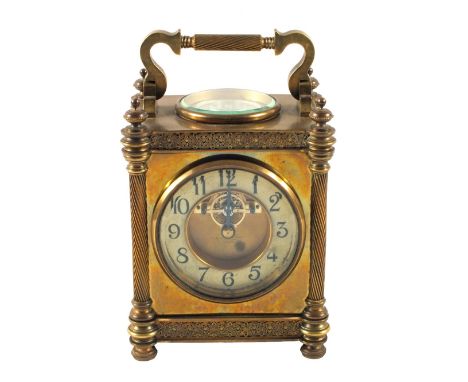 A substantial Brass carriage clock with column supports and decorative frieze with a painted chapter ring and visible escapem