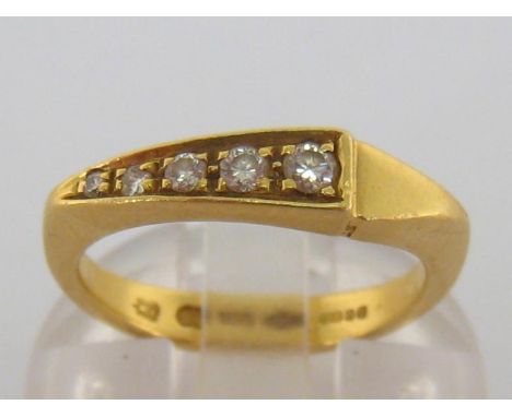 An 18 carat gold and diamond five stone ring, the five graduated diamonds in a tapering pave setting, the shank London import