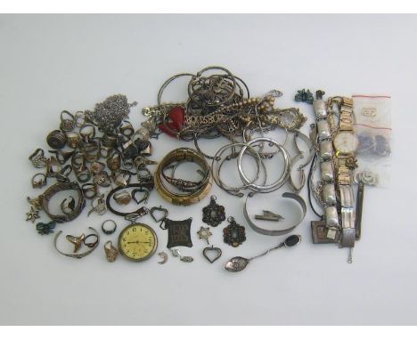 A mixed lot of white metal jewellery, including necklaces, bangles, brooches, and pendants; together with a nickel 15 jewel l