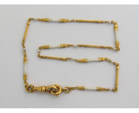 An early 20th century 18 carat gold, seed pearl and enamel chain, composed of alternate enamel and gold bar links, stamped ‘1