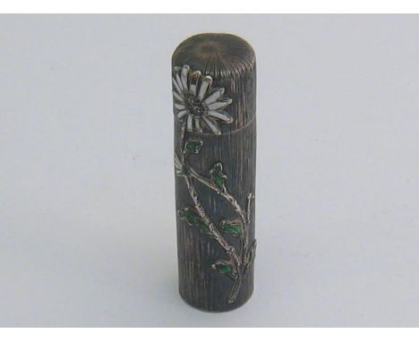 A silver and enamel scent bottle stamped “STERLING”, circa 1898, cylindrical with bark finish, applied with flowers on leafy 