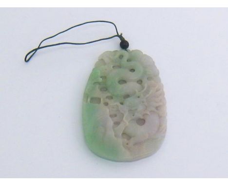 A green and white jade pendant carved with a dragon on the front face, a bird on the back. 10x6.5cm. 