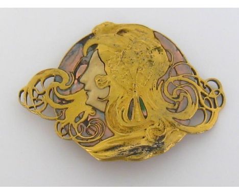 A French Art Nouveau gilt-metal, enamel and ivory belt buckle by Piels Frères of Paris, circa 1900, in the form of a girl’s f