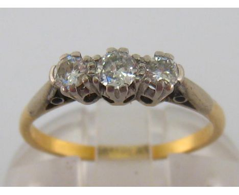 A three stone diamond ring, the three graduated brilliants totalling approx. 0.26 carat, the shank stamped ‘18ct PLAT’, finge