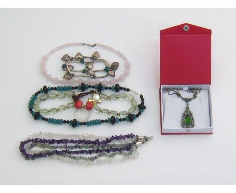 A mixed lot of necklaces, including a three strand quartz bead necklace, a rose quartz example, a marcasite and green stone p