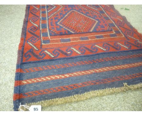 Meshwani carpet runner of red and blue ground, multi-bordered with repeating diamond central pattern, 258 x 67 cms
