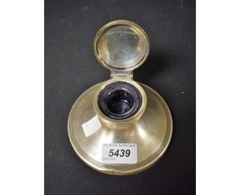 A silver capstan inkwell, hinged lid glass liner, rubbed hallmarks 