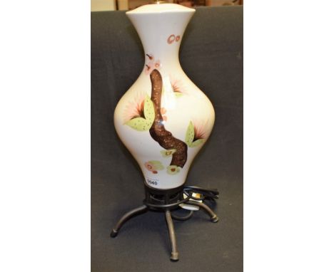 A 1950's table lamp, decorated with a succulent 