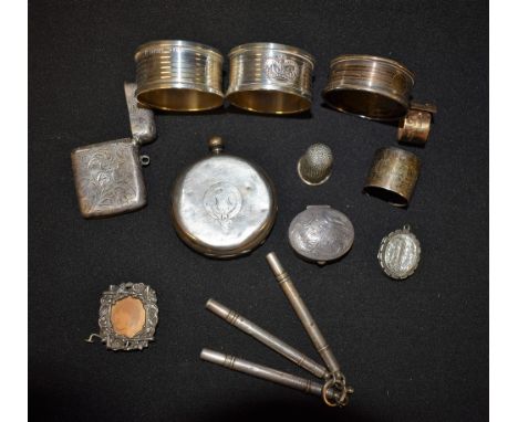 A silver vesta case, Birmingham 1903; a thimble, Birmingham 1910; a silver fob manicure set, Birmingham 1905; others, napkin 