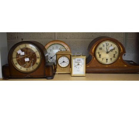 An Edwardian shaped and inlaid mahogany mantel clock; others, carriage clocks, 1930's mantel clock, etc (5)