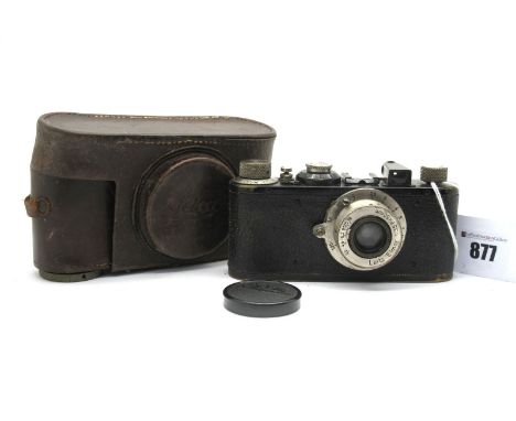 Ernst Leitz Wetzler Camera No 63058, fitted with a Elmar 1.35 f=50mm lens, in a leather case.