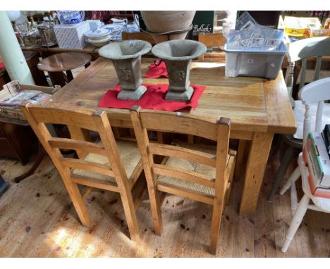 Rectangular rustic style oak dining table with frieze drawer together with a set of four rush seated ladder back dining chair