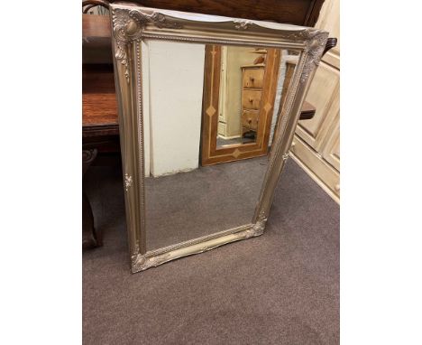 Silvered swept framed bevelled wall mirror, 106cm by 75cm overall.