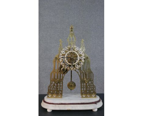 A Victorian brass skeleton clock: a fretted chapter ring with Roman numerals, with an eight day single train chain fusee move