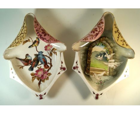 A pair of hand-painted ceramic wall plaques Possibly Zsolnay Pecs, each of shaped oval form decorasted with birds in landscap