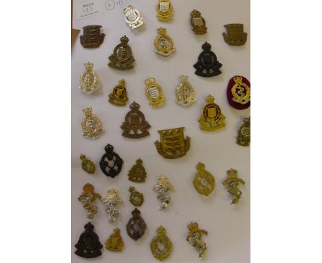 Approximately one hundred and thirty cap badges, early to mid 20th CenturyComprising the Royal Army Chaplains Corps, Royal Fl