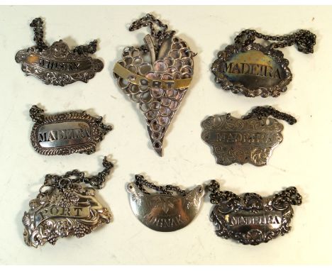 Seven George III and later hallmarked silver decanter labelsVarious designs and shapes to include a heavy gauge example decor