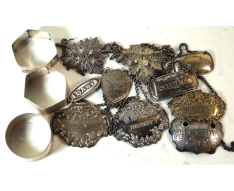 Nine assorted silver-plated decanter labelsVarious shapes and patterns, together with a hallmarked silver brooch stamped 'Bab