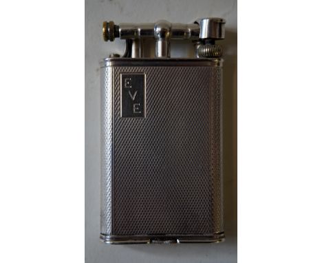 A George V Art Deco hallmarked silver Dunhill pocket lighterOf narrow rectangular form, having engine turned decoration, havi