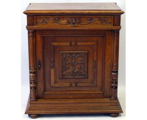 A Victorian honey oak side cupboard in an early Flemish tasteFeaturing intricately carved frieze drawer with nicely cast gilt