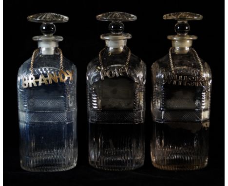 A set of three 19th Century cut glass decantersIn the Regency style, each of square form having cut decoration, each complete