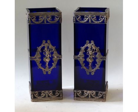 A pair of reproduction blue glass vases of square formHaving white metal applied decoration of a goddess playing a tambourine