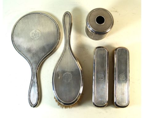 A late Victorian hallmarked silver five piece dressing table setComprising hair tidy, hand mirror, hair and two cloths brushe
