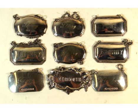 Nine contemporary hallmarked silver decanter labelsTo include two sets of three, a pair and a single example having cast grap