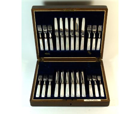 A George V hallmarked silver and mother of pearl twelve setting serviceComprising twelve forks and twelve knifes, made by All