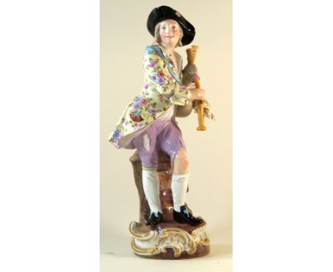 A large 19th Century Meissen porcelain figure groupModelled in the form of a boy playing the bagpipes, blue painted cross swo