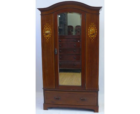 An Edwardian marquetry inlaid mahogany wardrobe, c.1900The domed moulded cornice above central bevelled mirrored door, flanke