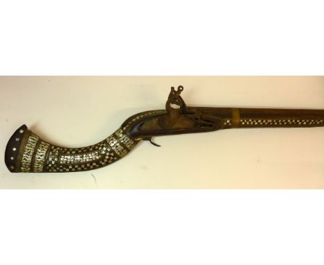 A Flintlock Jezail musket mid 19th Century94cm barrel with flared muzzle, fully stocked with decorative brass and mother of p