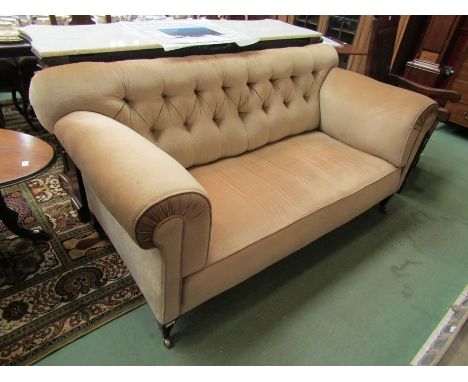 Circa 1860 a Howards style country house sofa the button back rest and scroll arms on square tapering fore legs and brass cas