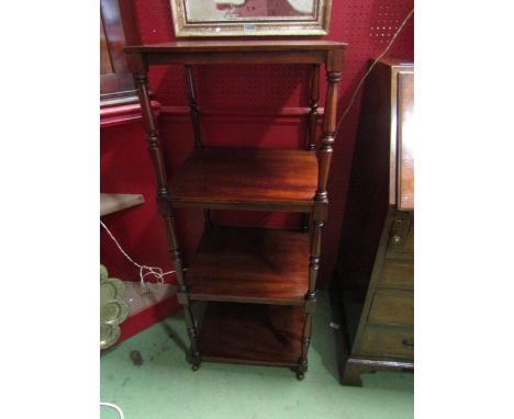 A 19th Century mahogany four tier whatnot on turned supports and ceramic castors. 113cm x 45cm x 40cm 