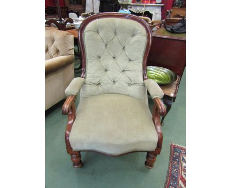A mid Victorian walnut spoon/button back rest armchair on scroll arms over a serpentine front seat on turned legs and castors