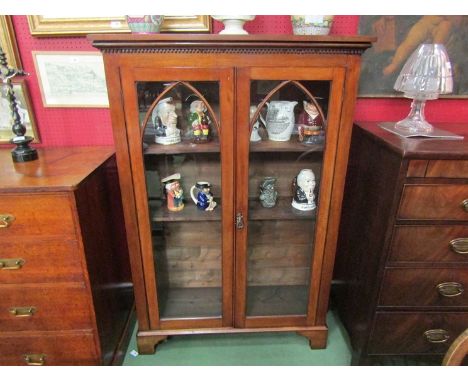 A Victorian mahogany arched glazed two door bookcase with working lock and key the height adjustable shelves over bracket fee