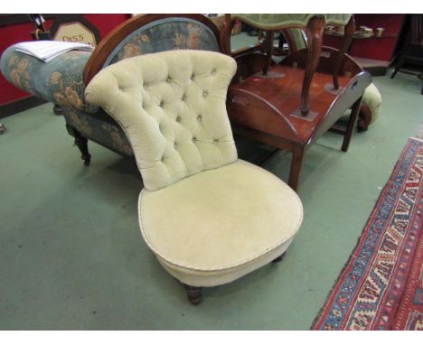 A Victorian nursing chair with button back upholstery on ceramic casters 