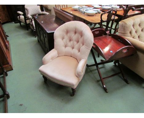 A Circa 1900 rounded top button backrest bedroom armchair the serpentine front seat over ring turned and tapering walnut fore