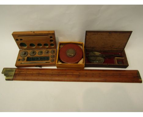 A Chesterman leather bound tape measure, Aston &amp; Mander folding right angle rule, boxed scale and boxed weights (4) 