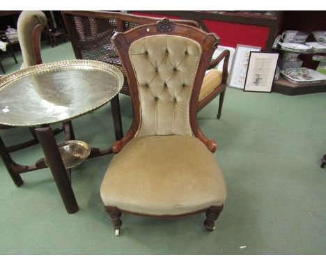 A Victorian mahogany button back bedroom chair with ceramic castors 