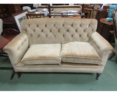 A late Victorian button back two seater sofa, the scroll arms over square tapering mahogany feet with line inlay decoration o